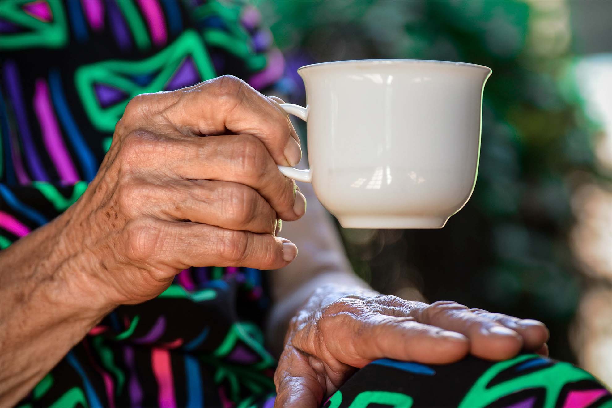 cup of tea in old persons hand