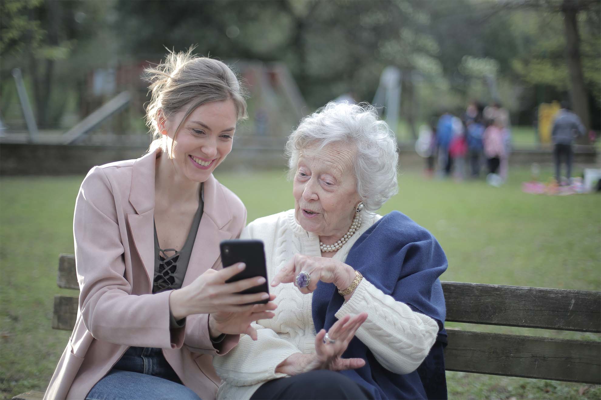 old woman with family member on bench